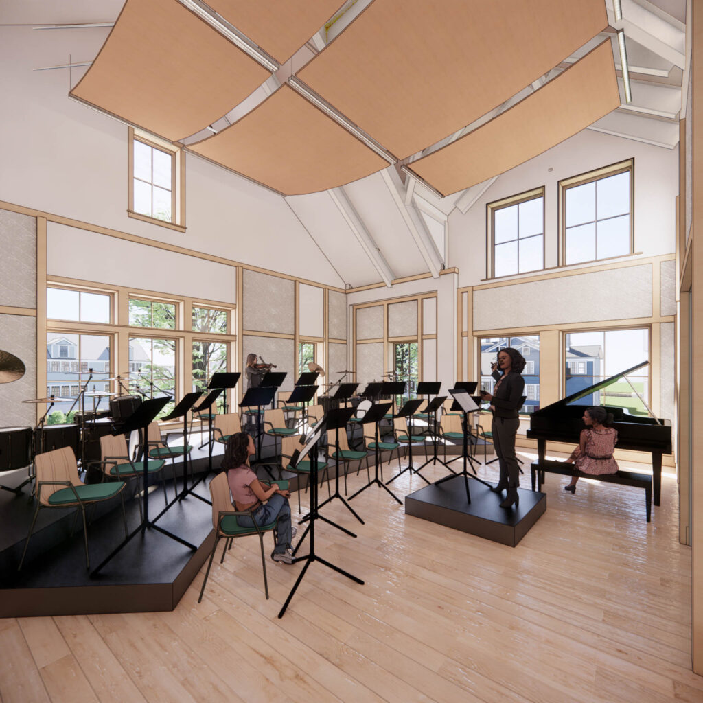 A group of musicians rehearses in a well-lit room with large windows and wooden floors. Music stands and chairs are arranged around the space. A pianist is seated at a grand piano.