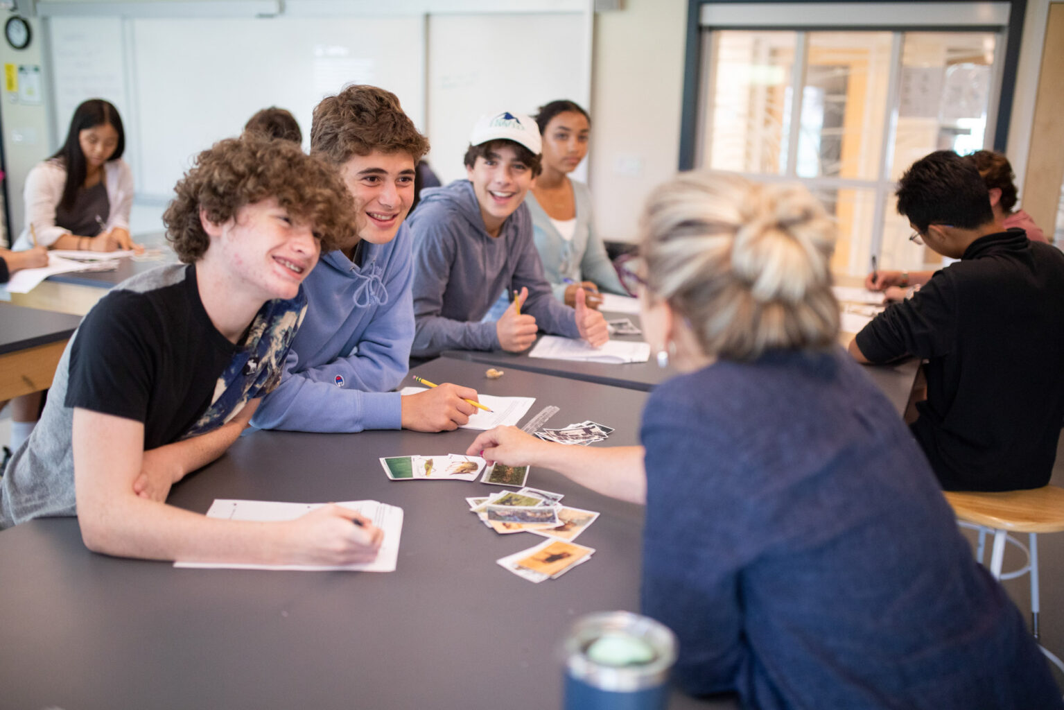 A teacher assisting a group of students.