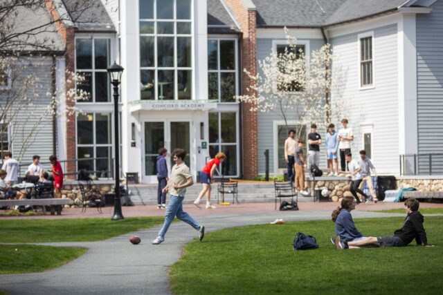 Students play on the quad in front of the Concord Academy Main School entrance.